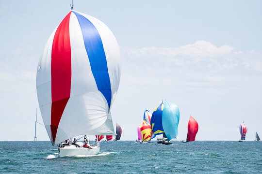 Boats sailing by Wind Turbines in New England