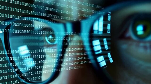 A close-up of a person's face is shown, but the emphasis is on his eyes and glasses. Rows of binary code are visible in the reflection of the lenses of the glasses