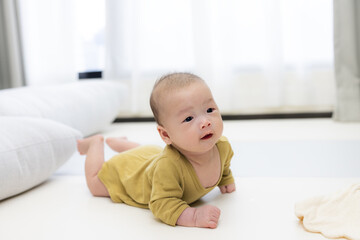 Fototapeta premium Infant lying on soft mat for rest