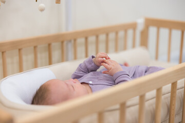 Baby sleeping peacefully inside the crib