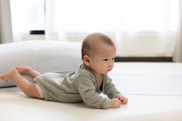 Baby lying on bed during tummy time exercise