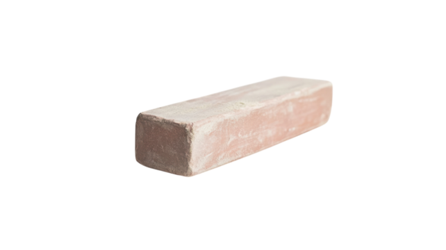 A close-up of a piece of chalk resting on a dusty surface, perfect for illustrating educational themes, art projects, or classroom settings, showcasing the texture and simplicity of writing tools..