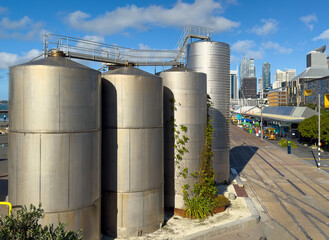 Auckland, New Zealand. Silo Park on the waterfront. Old cement tank farm that has been turned into a park. North Wharf bars and eateries and CBD skyline in distance.
