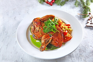 Grilled chicken with quinoa and bell pepper on white plate. Festive menu.