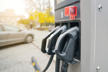 EV charger plugs closeup. Electric car charging station showing modern ev charger plugs in an urban area, clean energy solutions for sustainable transportation and eco-friendly technology