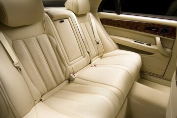 Luxurious cream leather car back seats with headrests, showcasing comfort and elegance.