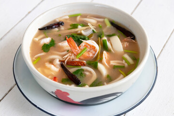 Spicy clear soup with fresh herbs 