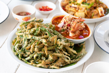 Spicy crispy morning glory salad (Yum Pak Boong Grob), is a tasty salad dish with fried morning glory and a savory spicy Thai sauce
