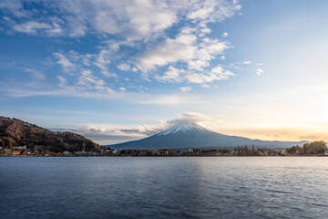View of Mount Fuji during sunset with moving cloud on top of the mountain