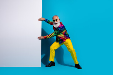 Full size photo of stylish charismatic aged man pull empty space placard isolated on blue color background