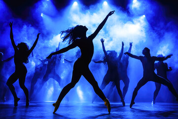 Energetic dance performance by young adults in blue light