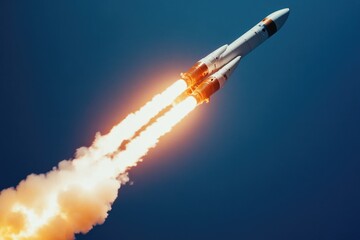A powerful rocket ascends into the deep blue sky, leaving a fiery trail of exhaust fumes.