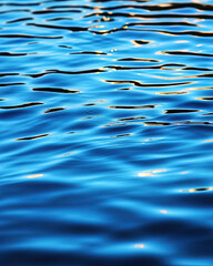 Rippling blue water surface serene lake nature photo calm environment close-up view tranquility concept