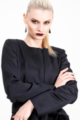 Obraz premium Woman in black dress posing in studio on white background. Fashion and advertising concept.