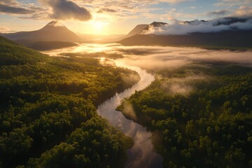 Fototapeta premium Sunrise over misty mountains and river in a serene forest landscape