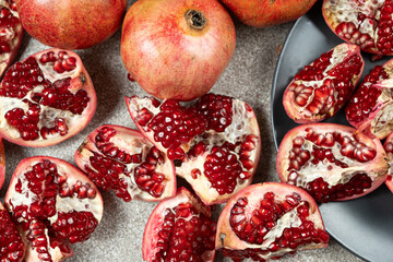 Ripe pomegranates, peeled and whole, the concept of benefits and vitamins in fruit.
