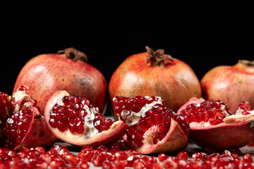 Ripe pomegranates, peeled and whole, the concept of benefits and vitamins in fruit.