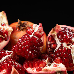 Ripe pomegranates, peeled and whole, the concept of benefits and vitamins in fruit.