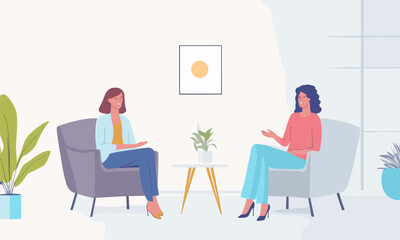 Two women sitting in chairs in a room