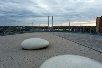 Square with stones on Arkhangelskaya street in Cherepovets, Arkhangelsky bridge over the Sheksna river, Vologda region, Russia