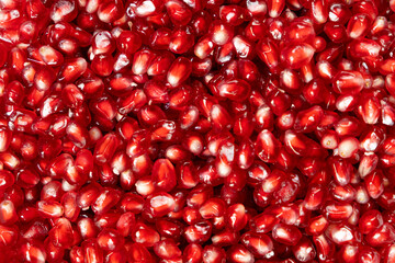 Ripe red pomegranate seeds close-up top view