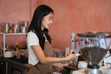 Young barista making coffee, coffee preparation service concept.