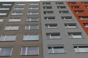 A captivating view of a large multistory apartment building showcasing a variety of vibrant colored facades
