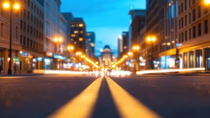 Obraz premium Urban Street at Dusk with Traffic Lights and Cityscape in the Background, Showcasing Blurred Motion of Vehicles and Illuminated Buildings in Evening Glow