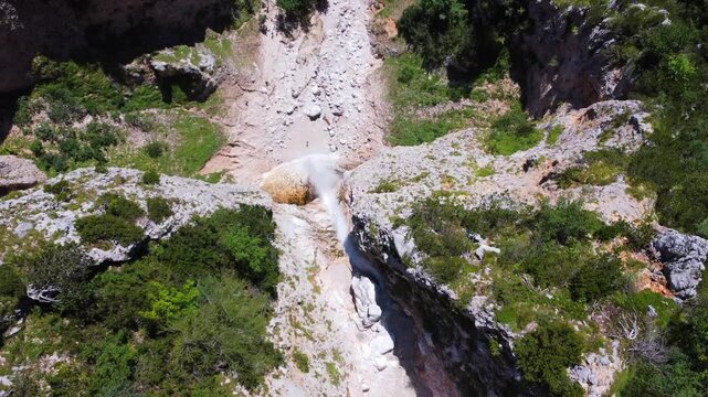 Aerial view capturing rinka waterfall cascading into the scenic logarska dolina valley, surrounded by lush greenery and rocky cliffs