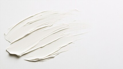 A smooth, flowing application of white paint on a clean surface, evoking a minimalist and artistic feel.
