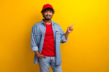 Cheerful young man wearing casual style and posing in front of a vibrant yellow background