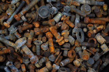 Group of old rusty nuts and screws from the vehicles waiting for recycle.