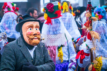 Ancient carnival with wooden masks from Sauris. Magic of Carnia for the arrival of spring.