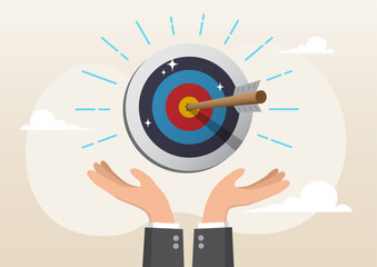 businessman hand hold target with arrow hit bullseye