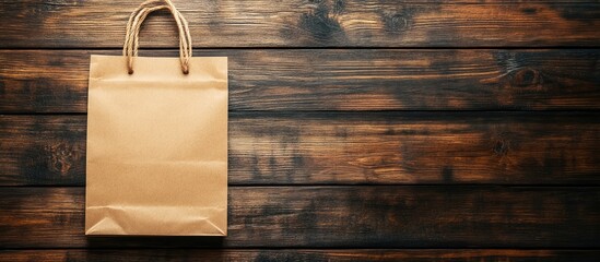 Blank paper bag on rustic wooden background ideal for personalized greeting or promotional text placement. Perfect for gift packaging needs.