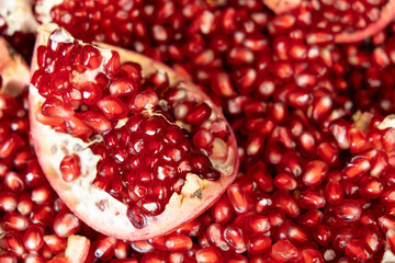 Pomegranate background, lots of peeled pomegranates and seeds