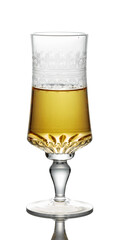 Gold liquor in a glass on a white background.