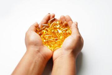 Fototapeta premium hand holding omega 3 capsules, fish oil