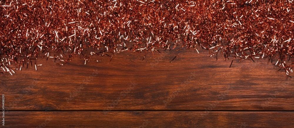 Aufkleber Christmas and New Year festive tinsel background on wooden table with empty space for text Flat lay composition top view