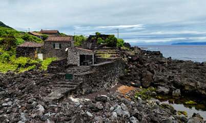 Traditional stone houses built from black volcanic rock on Azores, Pico island, Portugal