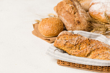 Homemade natural breads. Different kinds of fresh bread as background, perspective view with copy space