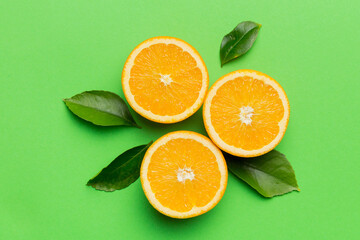 Fruit pattern of fresh orange slices on colored background. Top view. Copy Space. creative summer concept. Half of citrus in minimal flat lay
