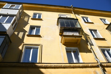 Architecture of old Soviet Union houses in Stalin's Empire style. Exterior of the facade of a vintage residential building in Russia