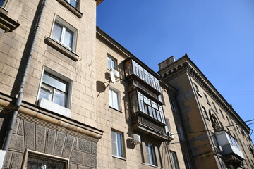 Architecture of old Soviet Union houses in Stalin's Empire style. Exterior of the facade of a vintage residential building in Russia