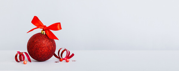 Christmas ball on colored background. decoration bauble with ribbon bow with copy space