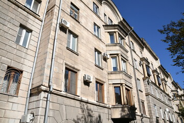 Architecture of old Soviet Union houses in Stalin's Empire style. Exterior of the facade of a vintage residential building in Russia