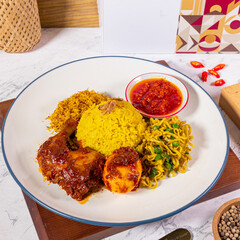 Yellow rice with chilli chicken, egg, serundeng, shredded chicken and sambal