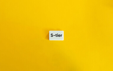 S-tier Term and Concept Image. Text on Block Letter Tile on Yellow Background.
