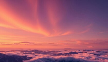 Fototapeta premium a view of a sunset over a mountain range with clouds