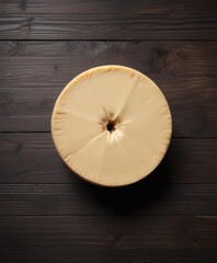 Isolated wheel of creamy white cheddar cheese on dark wood background,  cheddar,  food